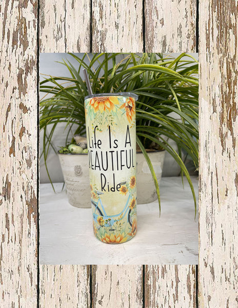 Yellow tumbler with blue boho themed bike and sunflower boarder, "Life is a beautiful ride" slim/skinny 20 oz stainless steel tumbler with clear lid